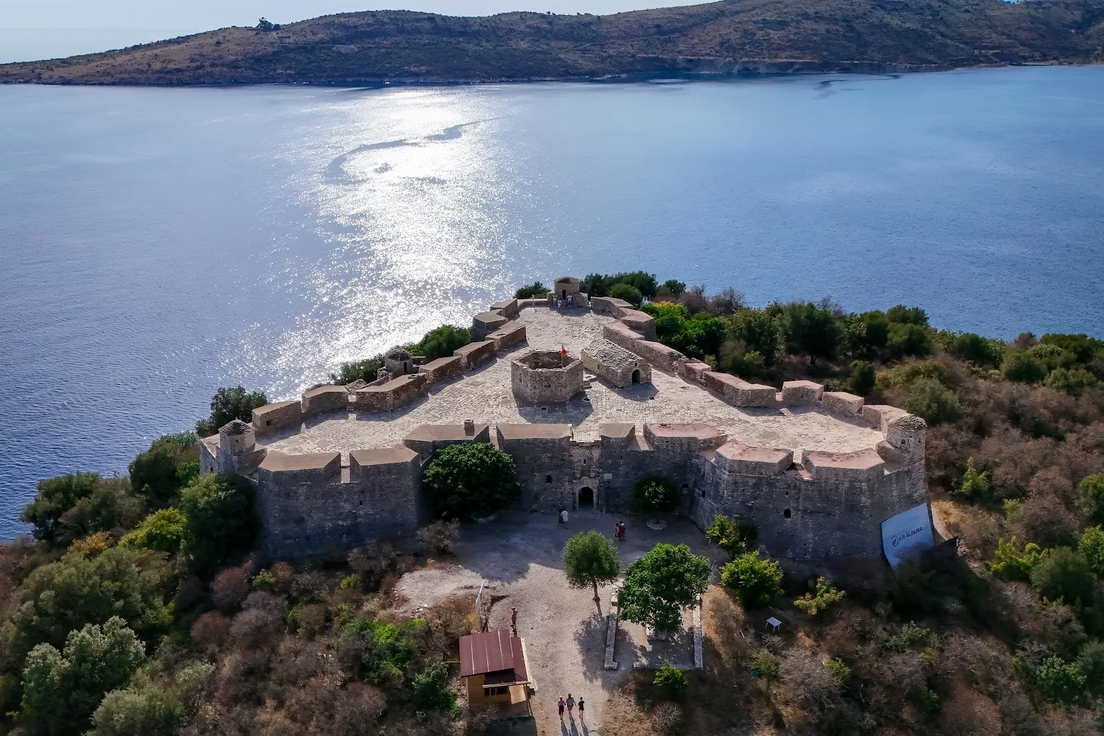 Porto Palermo Castle on its peninsula in the turquoise bay