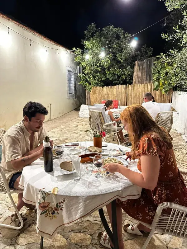 Bright dormitory with bunk beds and lockers at Natural Hostel in Himara