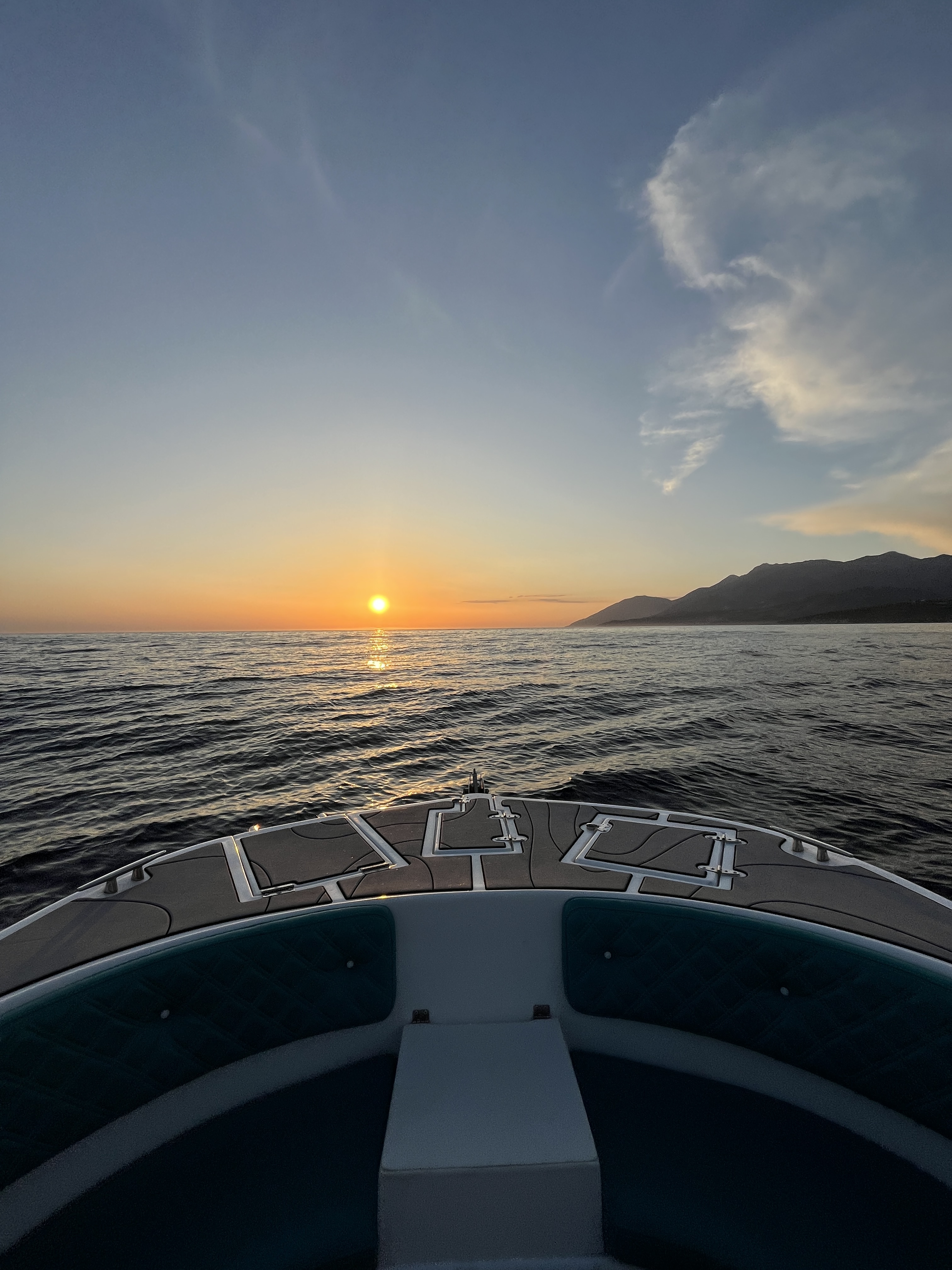 Himara bay at sunset seen from the sea during a transfer approach