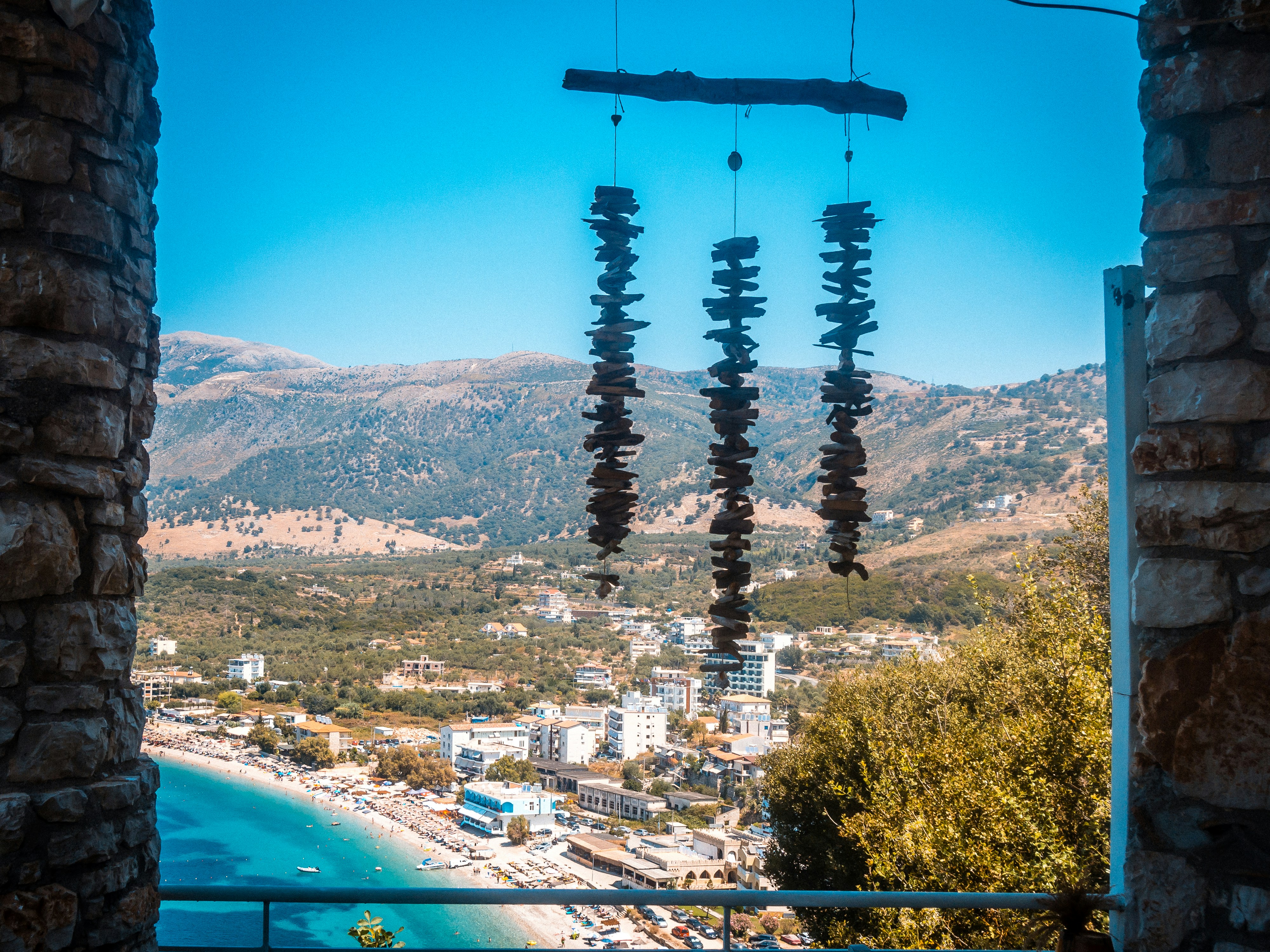 View through a stone arch at Spile Beach with turquoise water