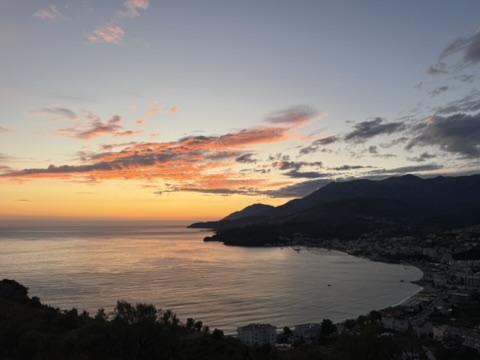 Aerial dusk view of Himara's Spile bay showing boutique hotel area