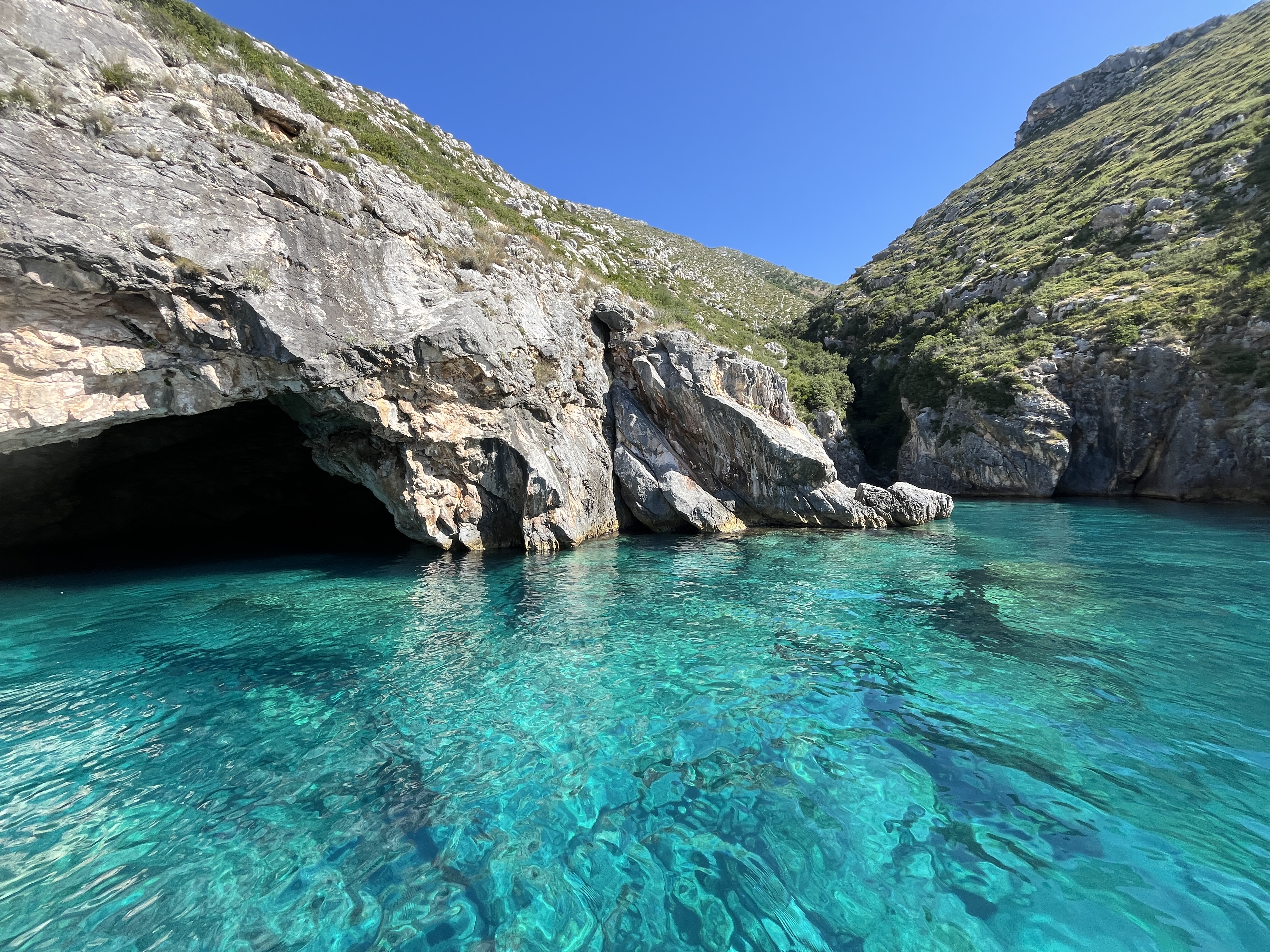 Rocky shoreline near Himara where water shoes are essential for comfortable beach access