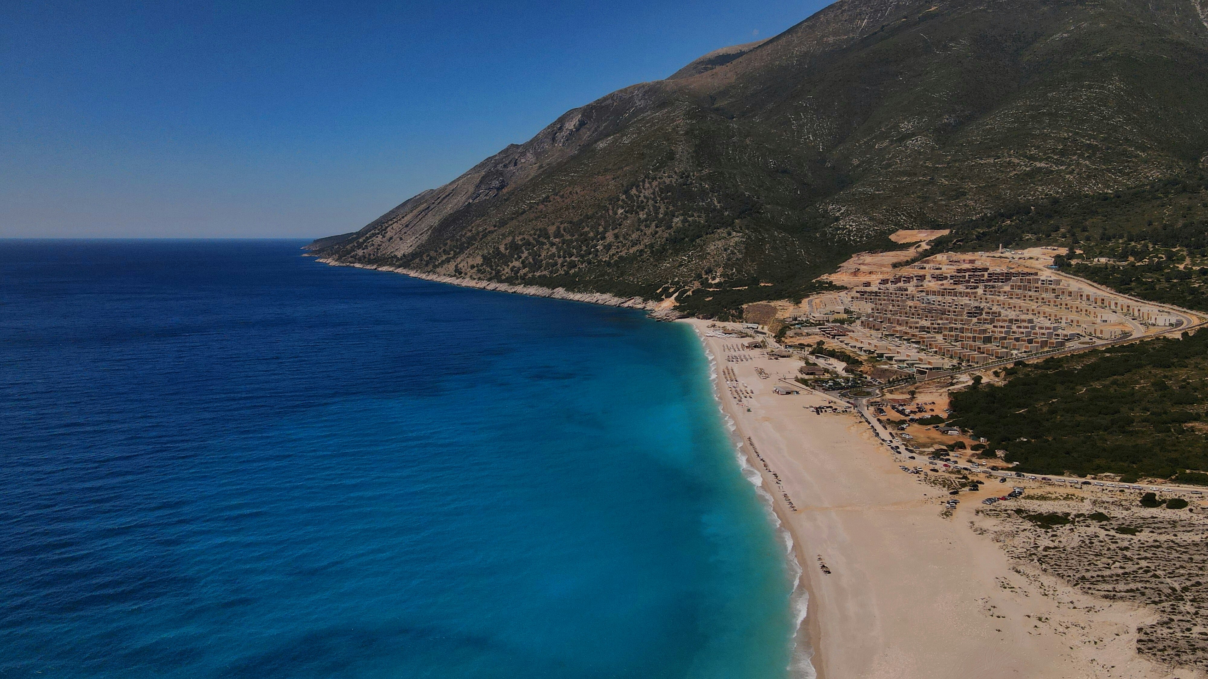 Aerial view of villas and coastline near Livadhi Beach in Himara