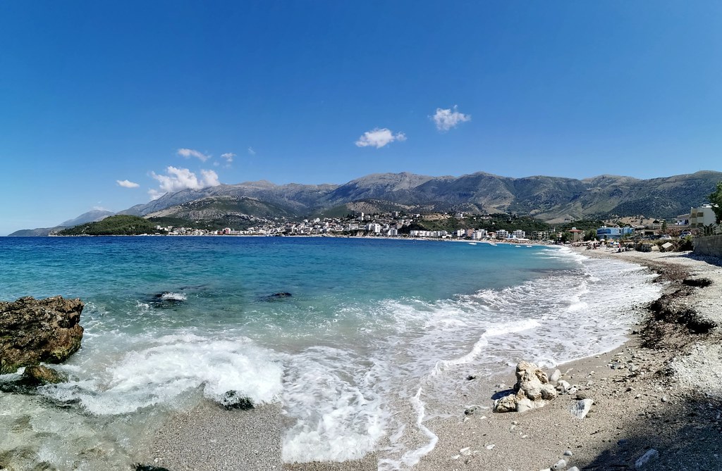 Livadhi Beach coastline with waves and Ceraunian Mountains