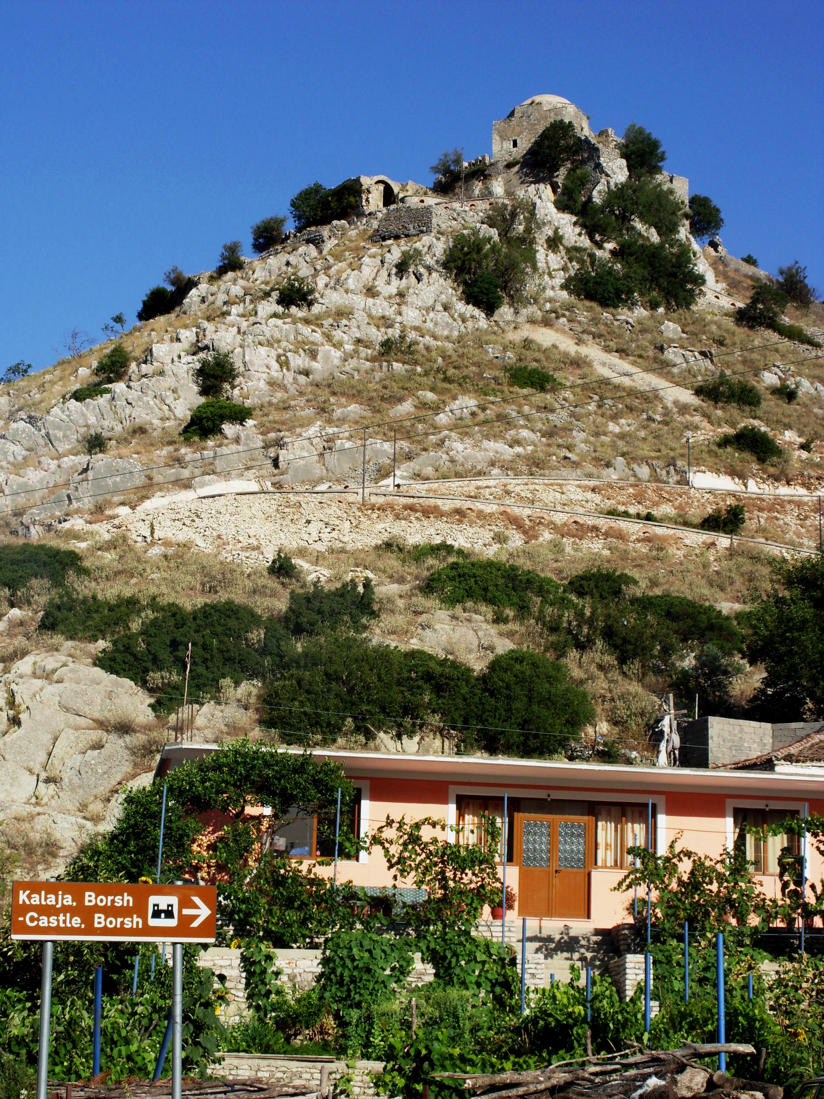 Ruins of Borsh Castle perched on a hilltop above the Albanian Riviera coastline