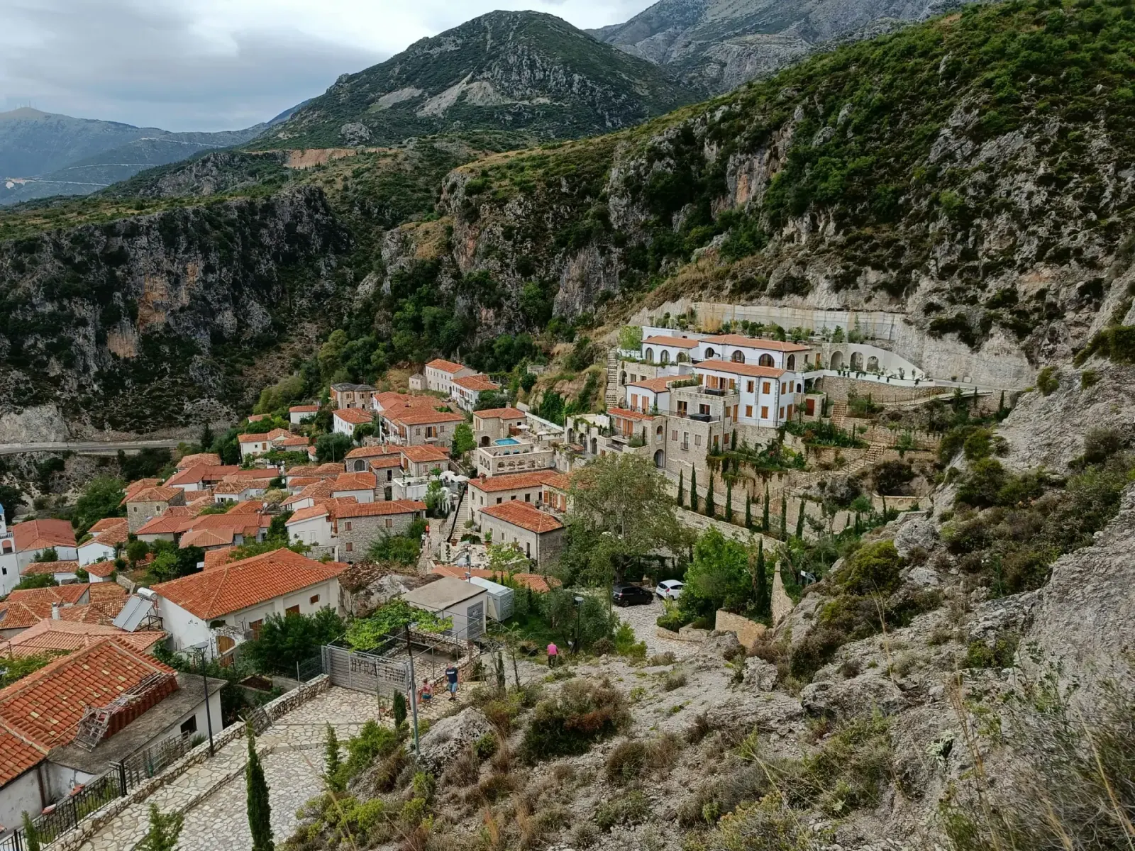 Coastal view of Livadhi Beach area near Himara with the village and road access visible from above