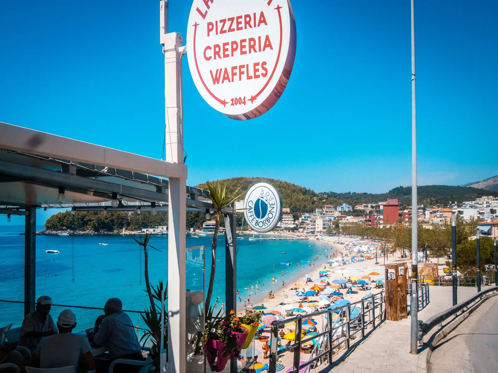 Seaside restaurants along Spile Beach promenade in Himara