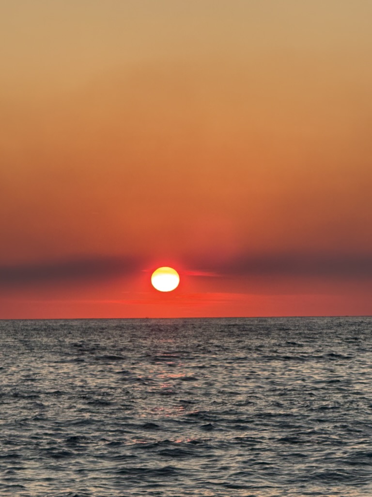 Albanian coastline at sunset where ride-hailing apps connect travelers across the Riviera