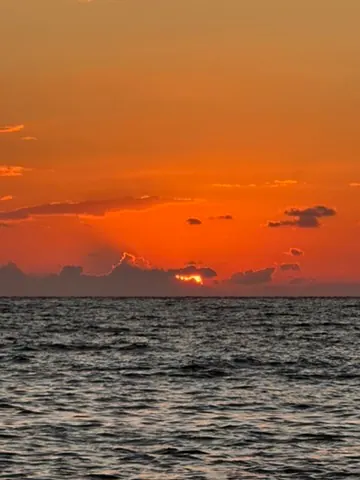 Sunset view over Spile Beach on the Albanian Riviera with calm Ionian waters