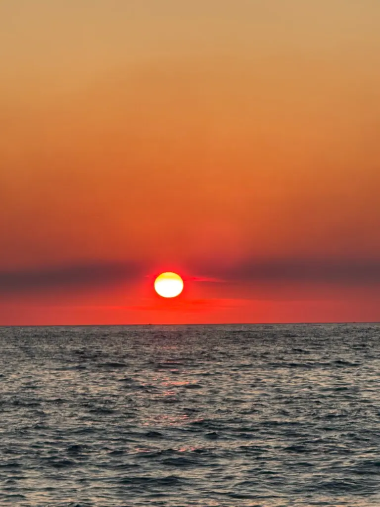 Albanian coastline at sunset where ride-hailing apps connect travelers across the Riviera